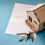 Casa, chaves e contrato representando empréstimo com garantia de imóvel